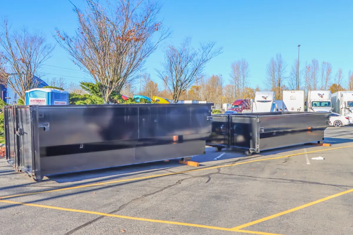 Professional dumpster rental service with roll-off container on residential driveway in Phillipsburg